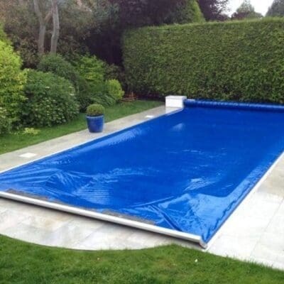 Rectangular pool with blue solar cover