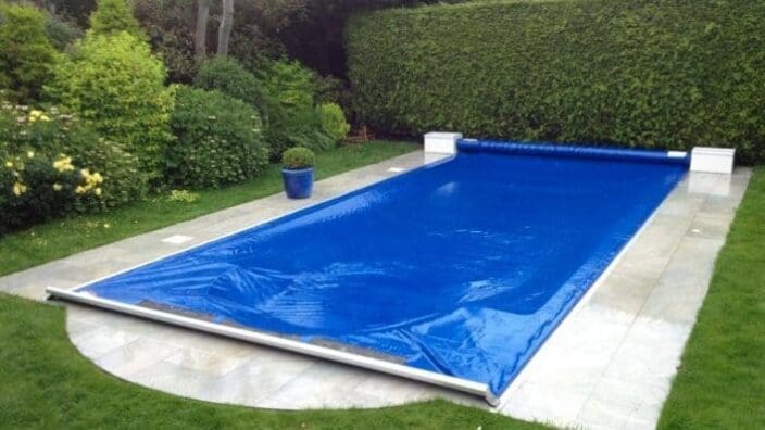 Rectangular pool with blue solar cover