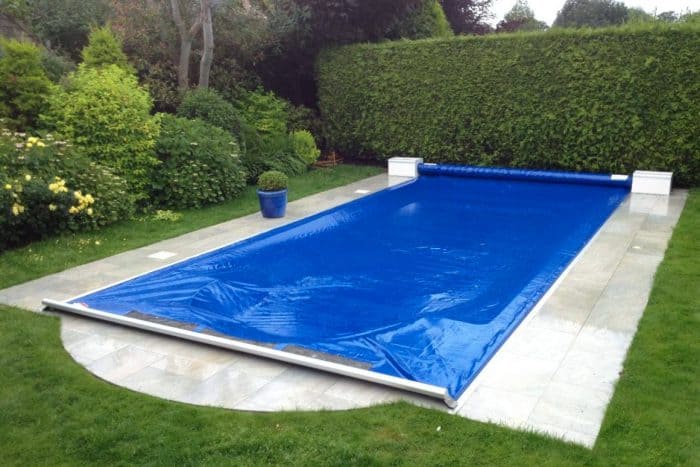 Rectangular pool with blue solar cover