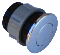 A chrome push-button drain plug rests on a white background, round polished cap with concentric circle and visible black rubber gasket on gray threaded plastic housing.