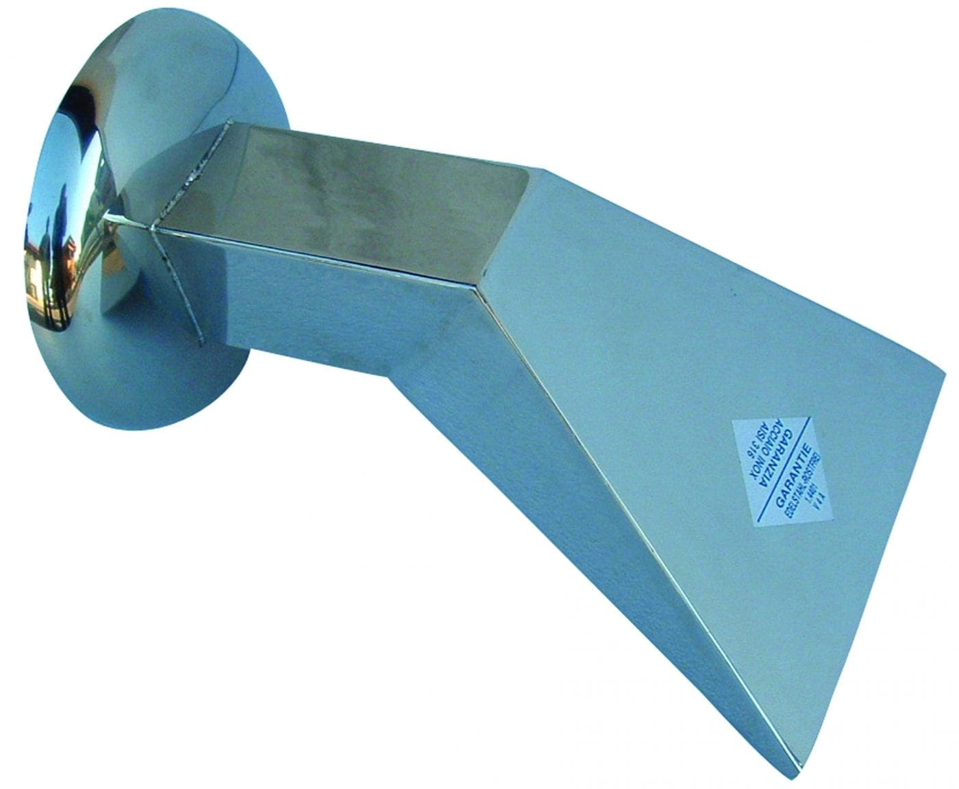 Polished chrome wall-mounted rectangular spout projects outward and angles downward, attached to round escutcheon; smooth metal surfaces reflect surroundings; small triangular white sticker with blue text is present but illegible.