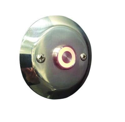 Circular stainless-steel wall plate mounted with two visible screws features a recessed round push button or indicator emitting soft pink light, centered against a plain white background.