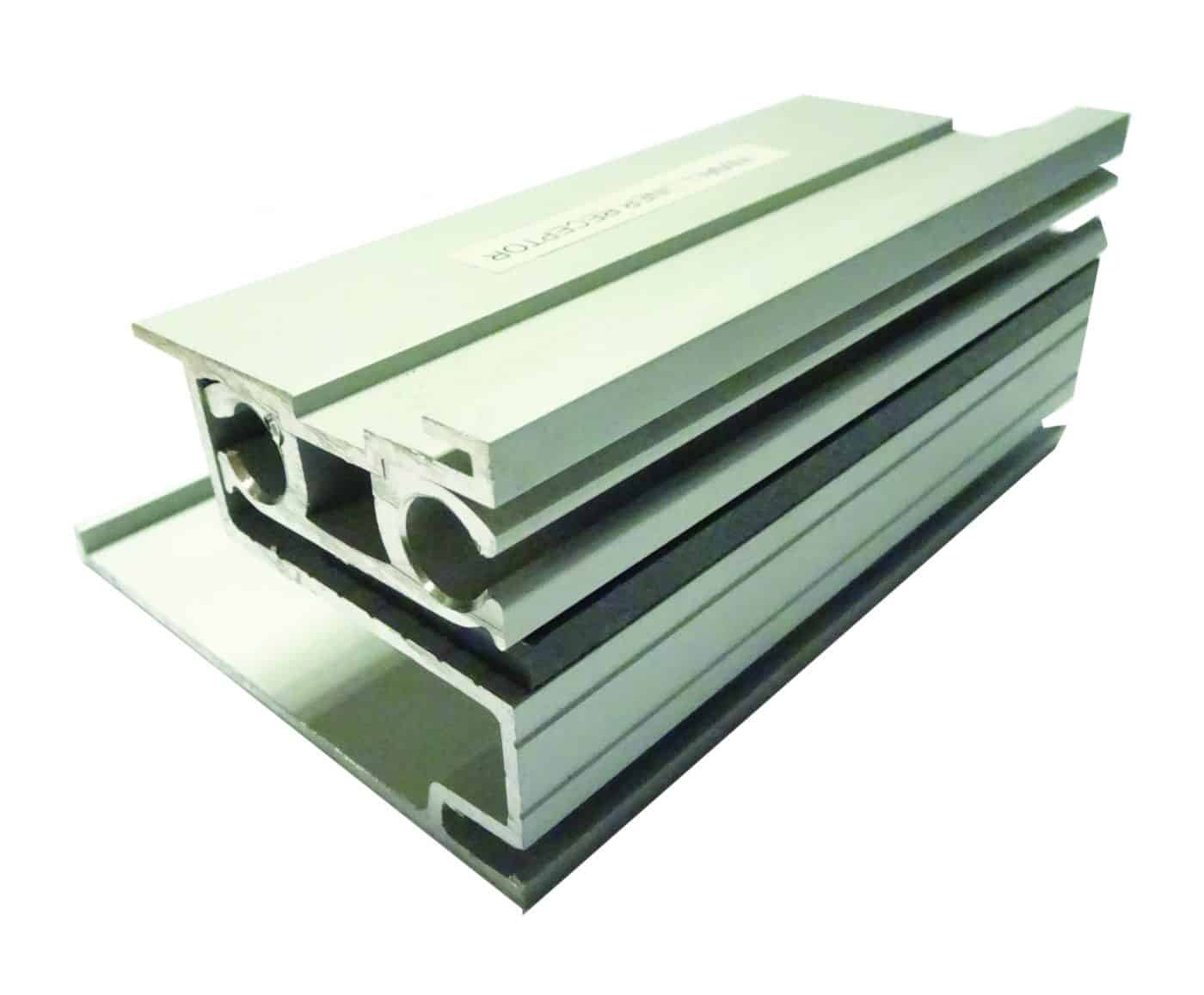 Aluminum extrusion profiles stacked diagonally, showing hollow channels and parallel grooves, resting on a white background under soft studio lighting.