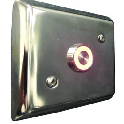 Chrome rectangular wall plate with a central circular push button glowing red; plate fastened by two screws, reflective finish mounted on a white wall.