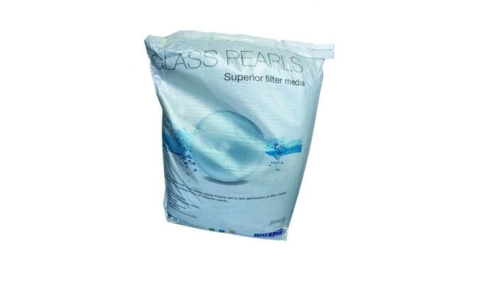 A white 20kg bag of glass filter beads stands upright on a white background, showing a glossy blue sphere graphic and product labeling, GLASS PEARLS Superior filter media 20KG WATERCO