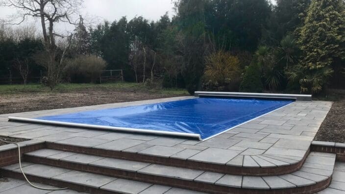 Swimming pool with blue cover