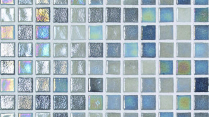 A grid of small glossy square mosaic tiles reflecting iridescent blue and silver hues, each separated by thin white grout, forming a uniform decorative tiled panel.