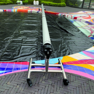 Indoor pool with manual roller cover system