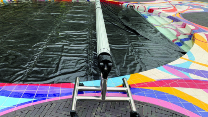 Indoor pool with manual roller cover system