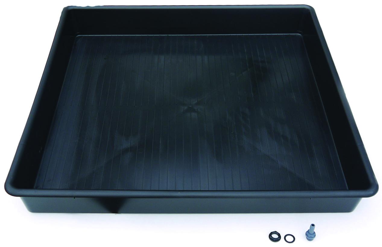 Black rectangular plastic tray sits empty on a white surface, ribbed interior visible; three fittings, a nut, O-ring and plastic nozzle, lie beside its front right corner.