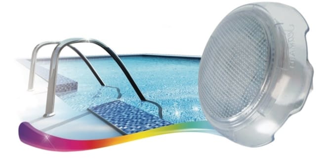 A translucent round pool light sits beside a tiled swimming pool as stainless-steel handrails and mosaic steps descend into clear blue water in a bright, minimal setting.