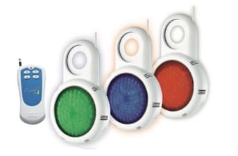 Three round LED fixtures glow green, blue, and red while suspended by white plastic hooks, accompanied by a small white remote control positioned to their left on a white background.
