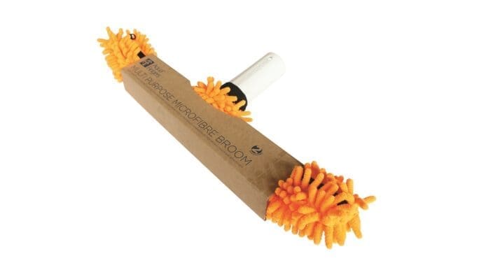 Orange microfibre broom head with white handle sits packaged in a brown sleeve labeled "MULTIPURPOSE MICROFIBRE BROOM" against a white background.