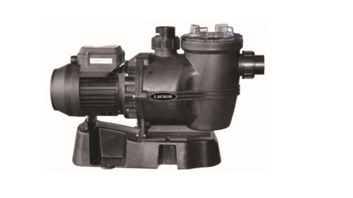 A Lacron pool pump sits and idle on a base, showing its motor, strainer housing with clear lid and inlet and outlet ports against a plain white background. Text: LACRON