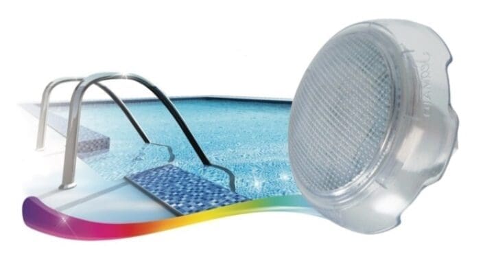 A round transparent pool light lens floats beside a pool ladder, showing blue tiled steps, shimmering water and a curved multicolor wave along the pool edge.